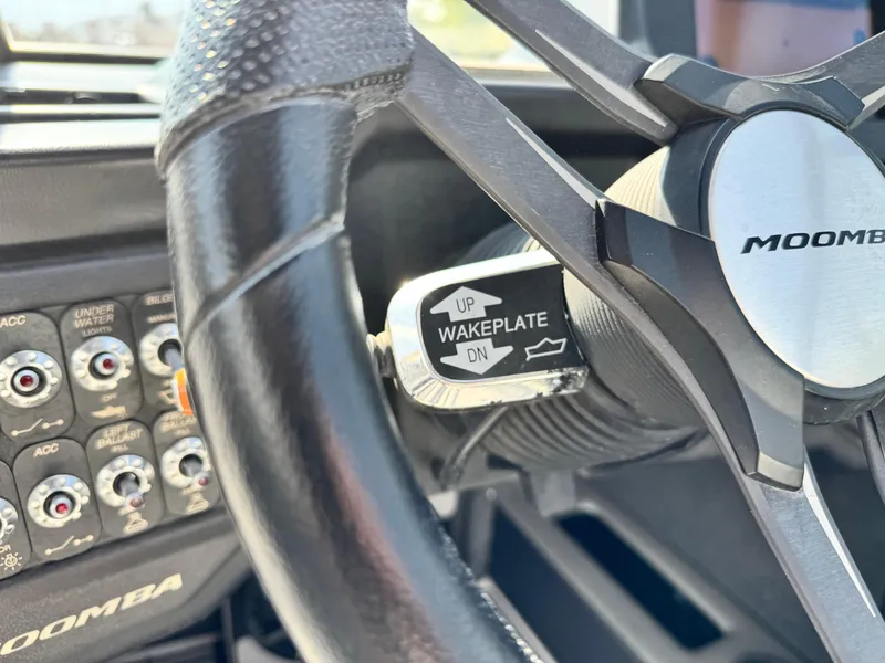 Slide: The Image of Steering wheel of 2021 Moomba Craz boat with wakeplate control and dashboard buttons. - 32