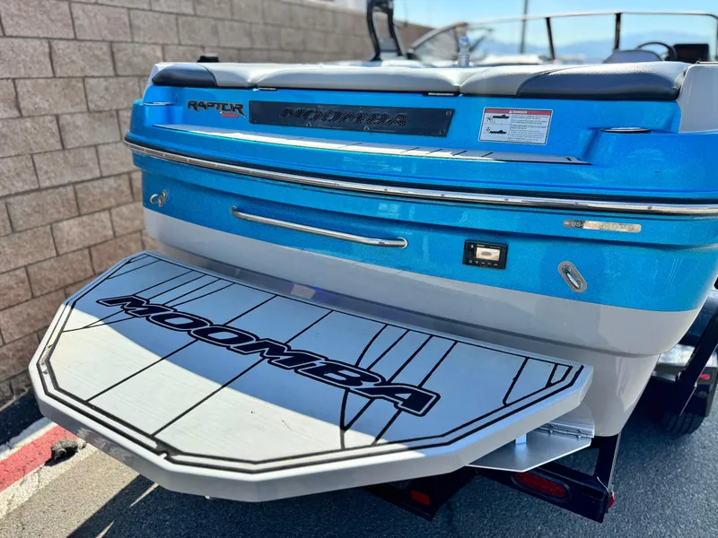 Slide: The Image of 2021 Moomba Craz boat rear view with swim platform, blue and white design. - 6