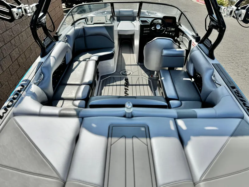 Slide: The Image of 2021 Moomba Craz boat interior with sleek gray seating and modern dashboard design. - 9