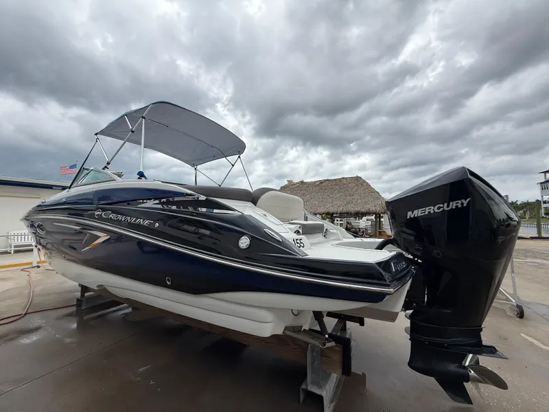 Slide: The Image of 2019 Crownline Eclipse E255 XS boat with Mercury engine under cloudy skies. - 17