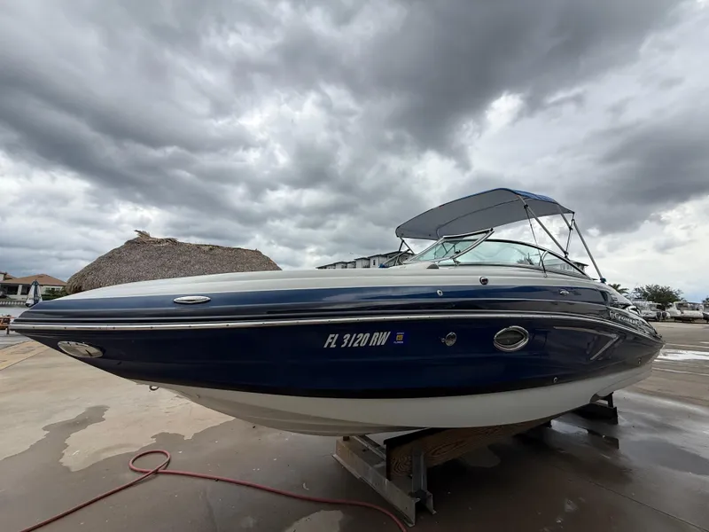 Slide: The Image of 2019 Crownline Eclipse E255 XS boat on display under cloudy skies. - 18