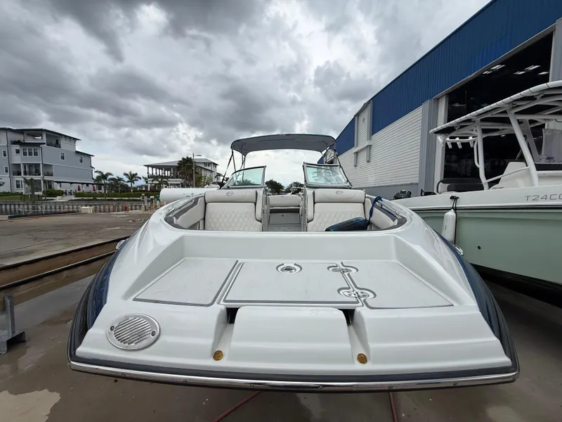 Slide: The Image of 2019 Crownline Eclipse E255 XS boat docked under cloudy skies. - 19