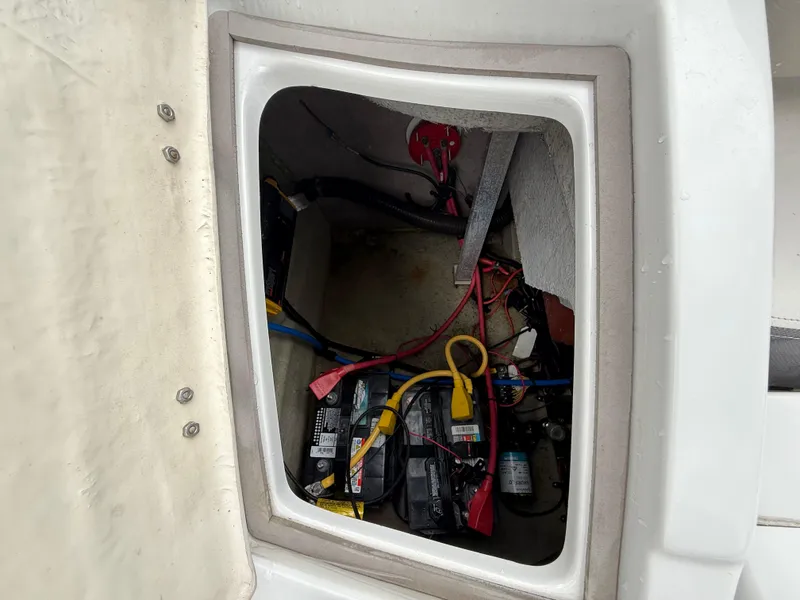 Slide: The Image of 2019 Crownline Eclipse E255 XS battery compartment with wiring and components. - 23