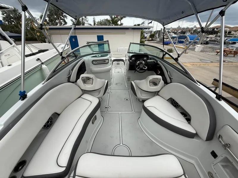 Slide: The Image of 2019 Crownline Eclipse E255 XS boat interior with spacious seating and canopy. - 25