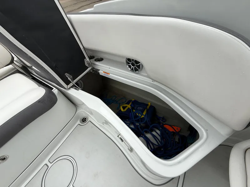 Slide: The Image of 2019 Crownline Eclipse E255 XS boat storage compartment with ropes and accessories. - 27