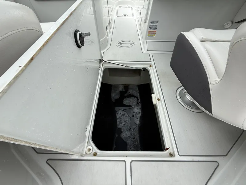 Slide: The Image of 2019 Crownline Eclipse E255 XS boat storage compartment open, revealing interior space. - 33