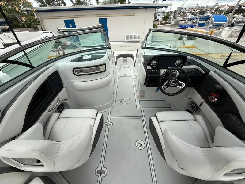 Slide: The Image of 2019 Crownline Eclipse E255 XS boat interior with white seating and modern dashboard. - 34