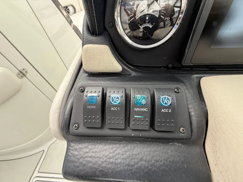 Slide: The Image of Control panel of 2019 Crownline Eclipse E255 XS boat with switches and speedometer. - 38