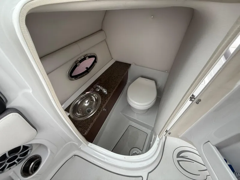 Slide: The Image of 2019 Crownline Eclipse E255 XS boat interior with compact bathroom amenities. - 45