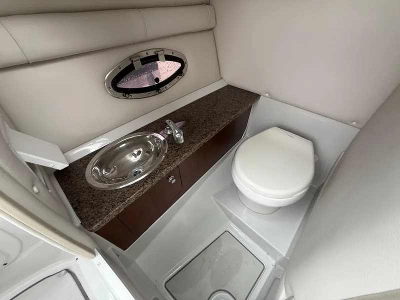 Slide: The Image of 2019 Crownline Eclipse E255 XS boat bathroom with sink and toilet. - 46