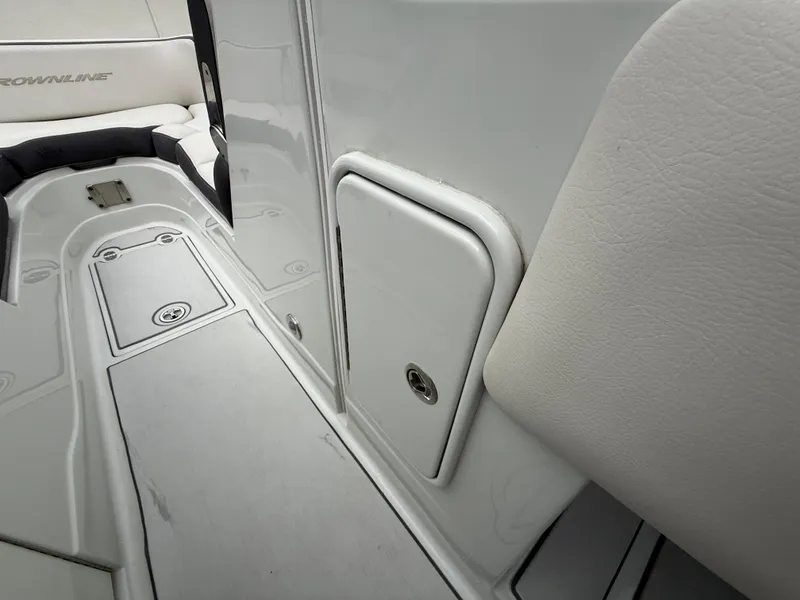 Slide: The Image of 2019 Crownline Eclipse E255 XS boat interior with storage compartment and seating area. - 48