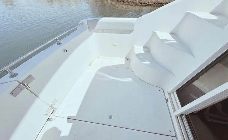 Slide: The Image of 2008 Carver 36 Mariner boat deck with white seating and steps. - 10