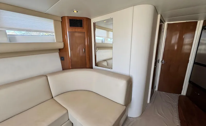 Slide: The Image of Interior of 2008 Carver 36 Mariner yacht with beige seating and wooden accents. - 14