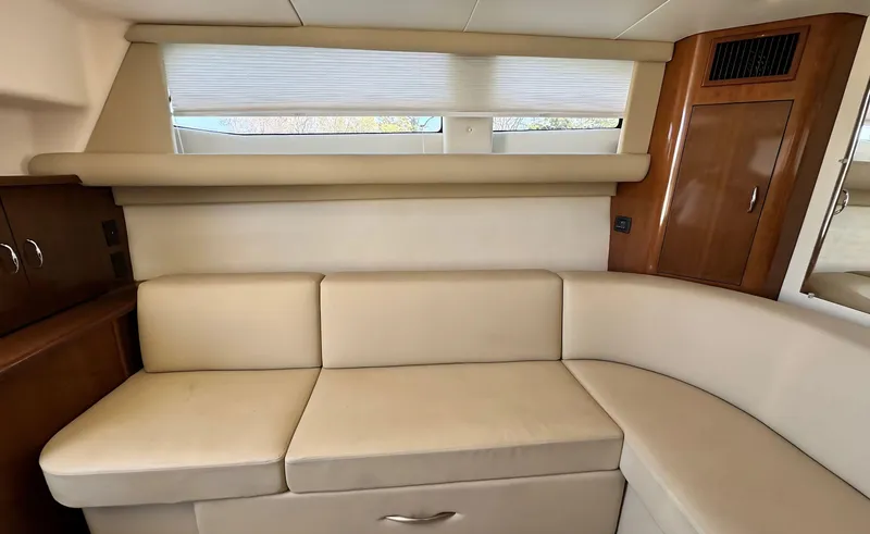 Slide: The Image of Interior of 2008 Carver 36 Mariner yacht with beige seating and wooden cabinetry. - 15