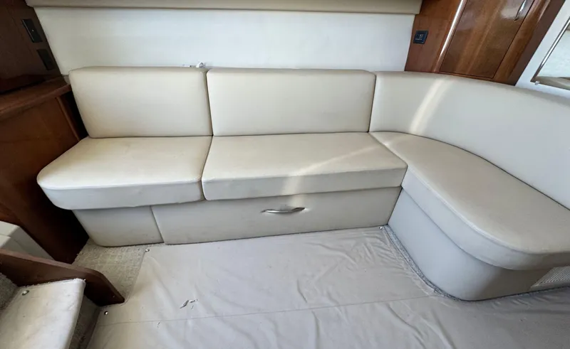 Slide: The Image of 2008 Carver 36 Mariner interior with beige leather seating and wooden accents. - 16