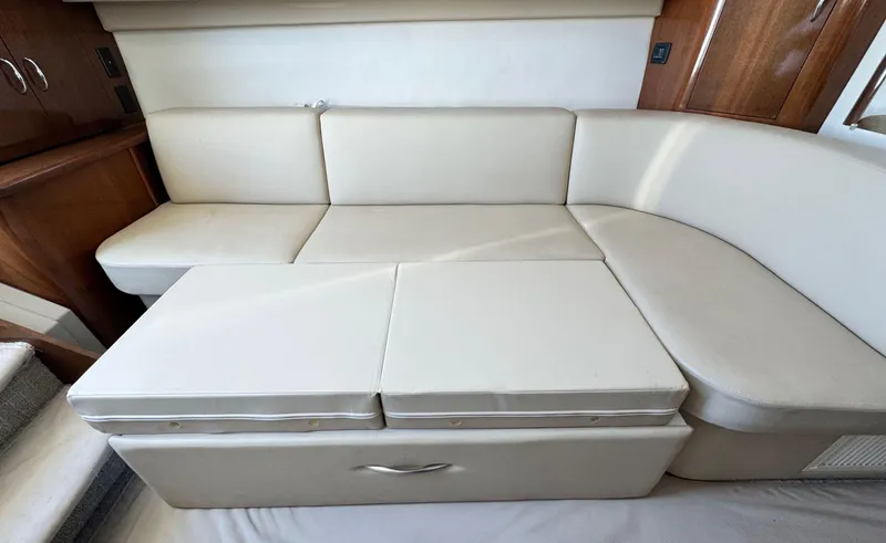 Slide: The Image of 2008 Carver 36 Mariner interior with beige leather seating and wooden accents. - 17