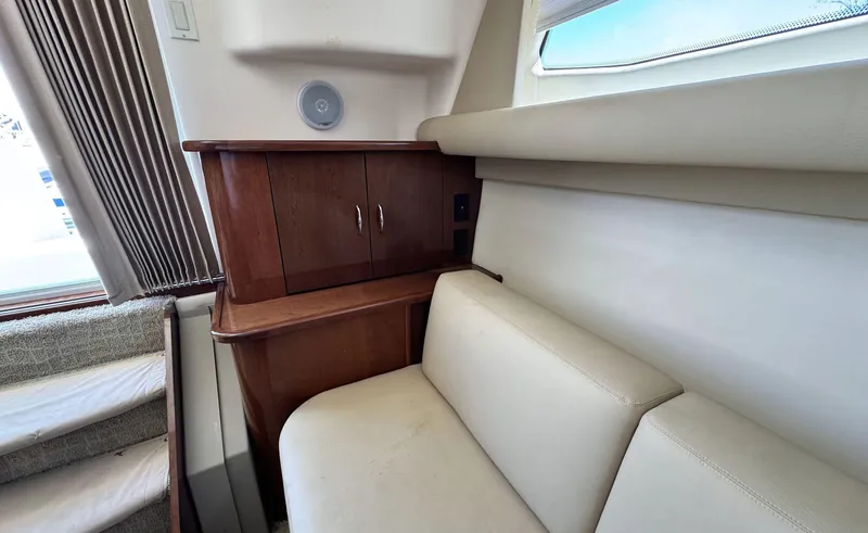 Slide: The Image of Interior of 2008 Carver 36 Mariner with beige seating and wooden cabinetry. - 18