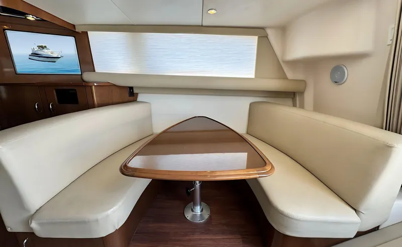 Slide: The Image of 2008 Carver 36 Mariner interior with beige seating and wooden table. - 21