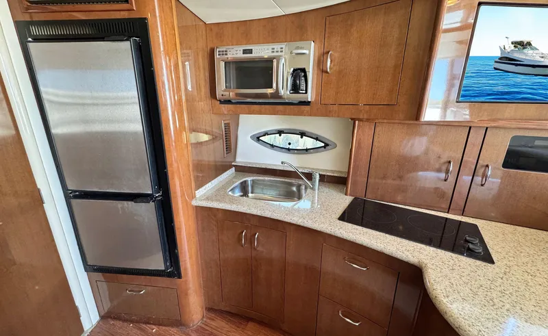 Slide: The Image of 2008 Carver 36 Mariner kitchen with wood cabinetry, stainless appliances, and countertop. - 22