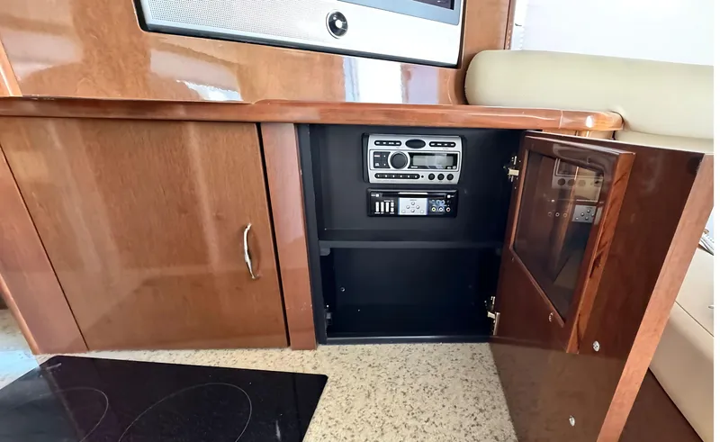 Slide: The Image of 2008 Carver 36 Mariner interior with wooden cabinetry and built-in audio system. - 24