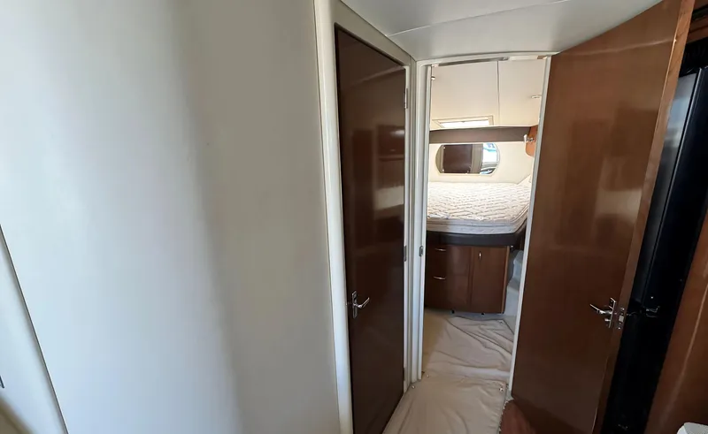 Slide: The Image of Interior hallway of 2008 Carver 36 Mariner yacht, featuring wooden doors and cabin access. - 25