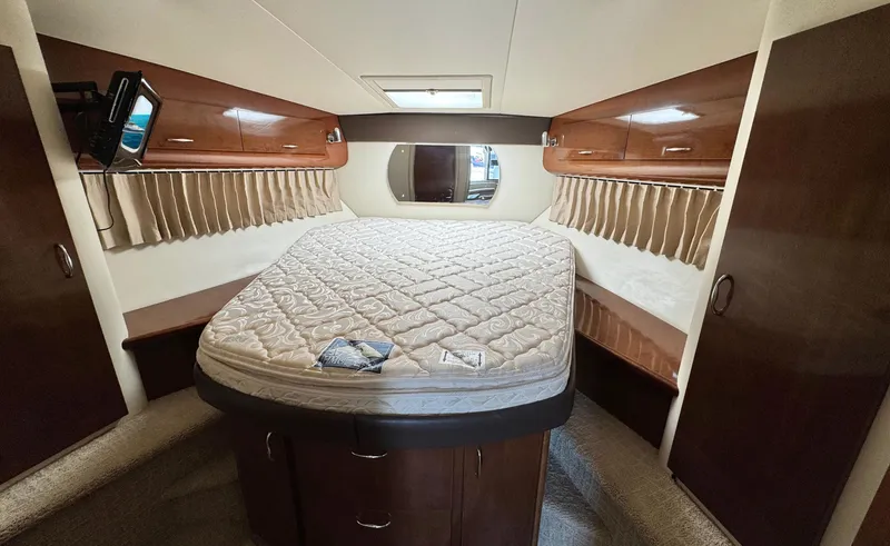 Slide: The Image of Interior cabin of 2008 Carver 36 Mariner with bed and wooden storage cabinets. - 29