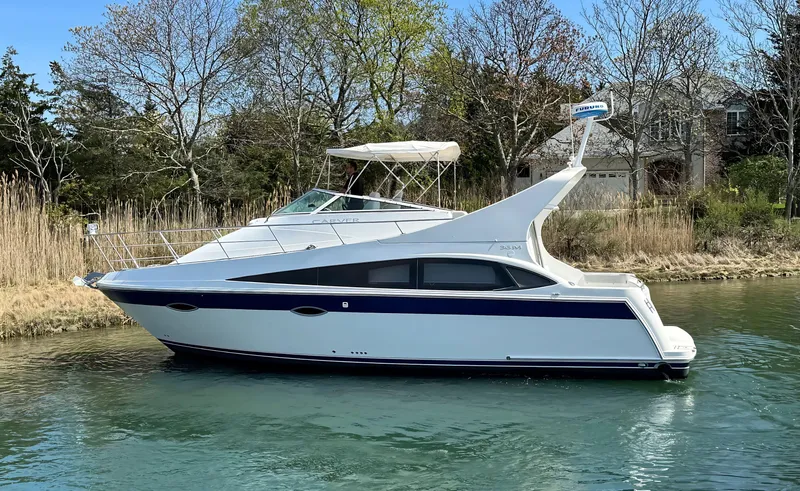 Slide: The Image of 2008 Carver 36 Mariner yacht on a calm waterway, surrounded by trees. - 3