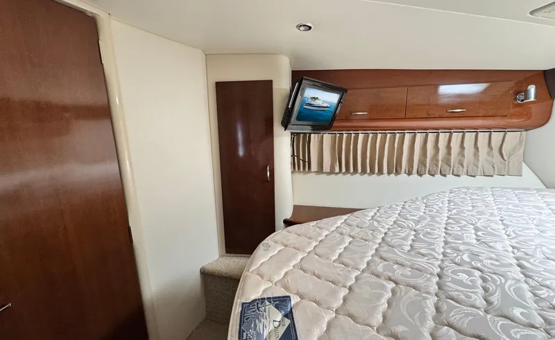 Slide: The Image of Interior of 2008 Carver 36 Mariner with bed, TV, and wooden cabinets. - 30