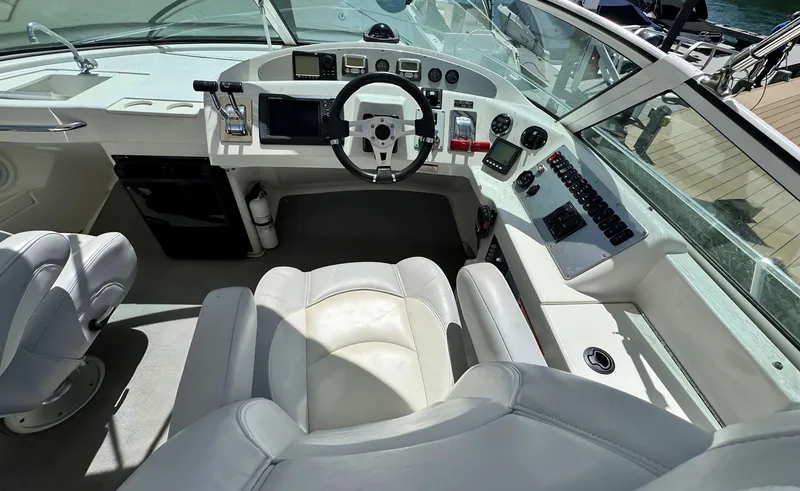 Slide: The Image of 2008 Carver 36 Mariner helm with white seating and modern controls. - 37