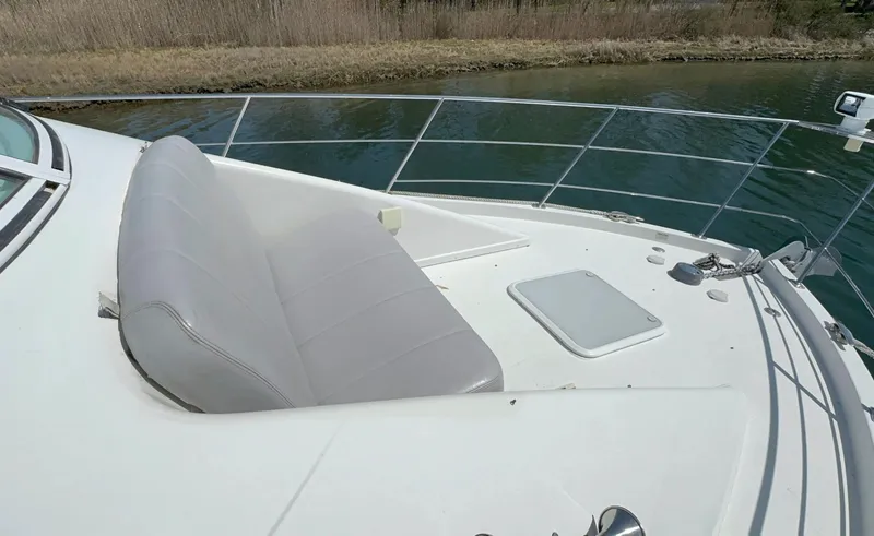 Slide: The Image of 2008 Carver 36 Mariner boat deck with seating and railing by the water. - 41