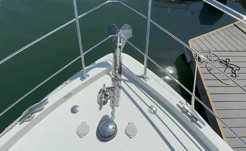 Slide: The Image of Bow of 2008 Carver 36 Mariner yacht with anchor and railing, docked at marina. - 42