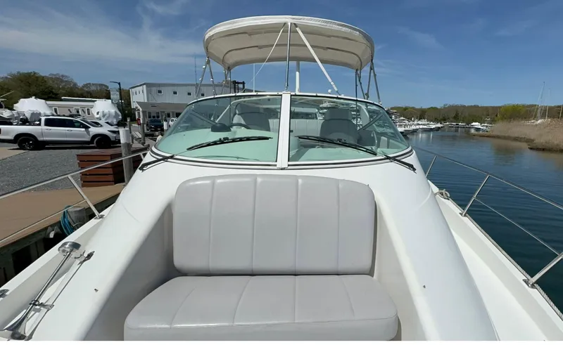 Slide: The Image of 2008 Carver 36 Mariner boat docked, featuring a spacious seating area and clear blue sky. - 43