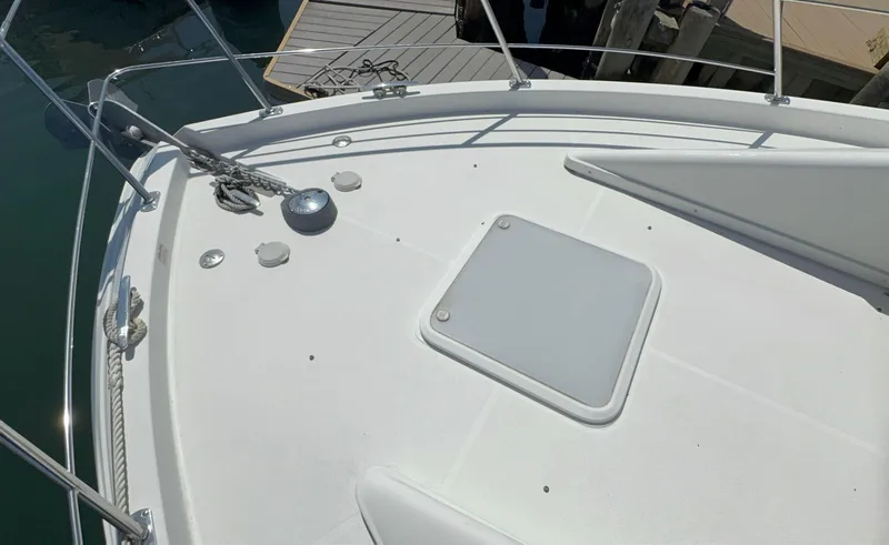 Slide: The Image of 2008 Carver 36 Mariner boat deck with anchor and hatch, docked at marina. - 44
