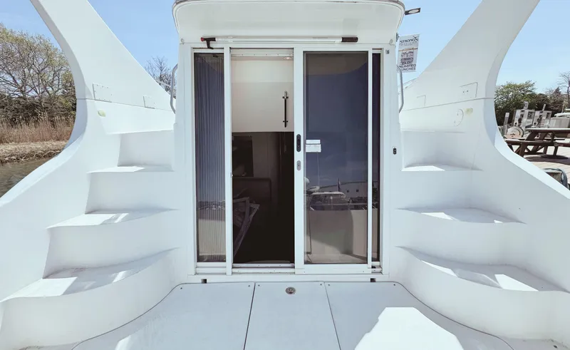 Slide: The Image of 2008 Carver 36 Mariner yacht with dual staircases and sliding glass door entry. - 8