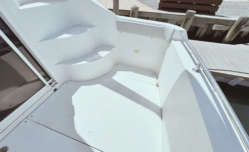 Slide: The Image of 2008 Carver 36 Mariner boat deck with white seating and steps. - 9