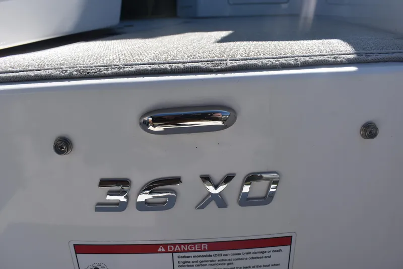 Slide: The Image of 2023 Regal 36 XO boat model nameplate with warning label. - 10