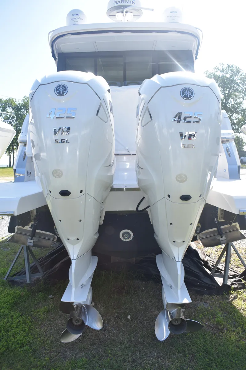 Slide: The Image of 2023 Regal 36 XO boat with twin outboard engines, rear view. - 13
