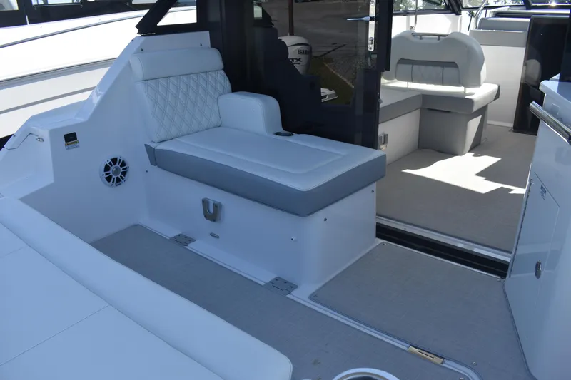 Slide: The Image of 2023 Regal 36 XO yacht interior with cushioned seating and modern design. - 16