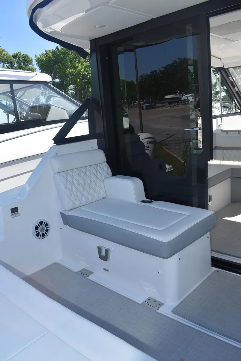 Slide: The Image of 2023 Regal 36 XO boat interior with cushioned seating and modern design. - 17