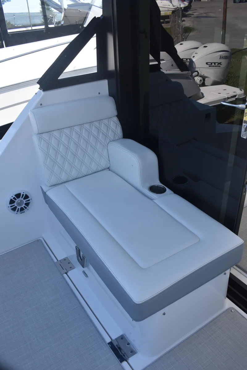 Slide: The Image of 2023 Regal 36 XO boat interior with white cushioned seating and cup holder. - 20