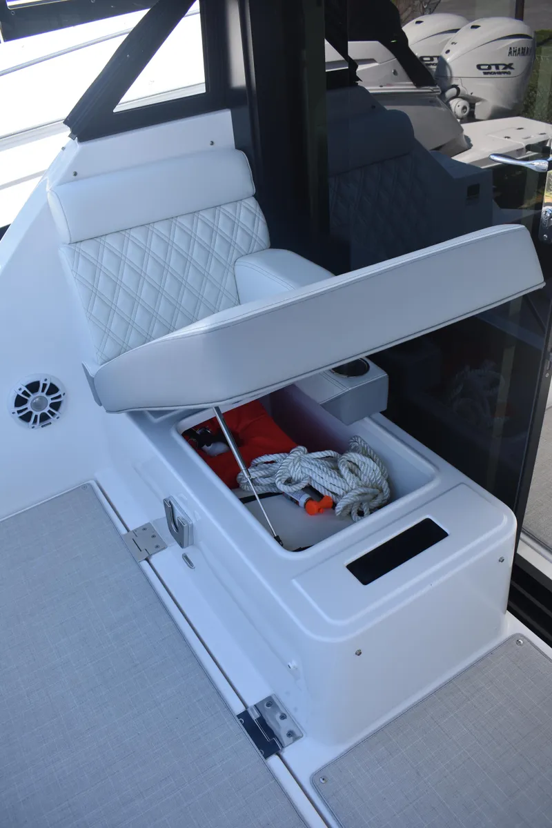 Slide: The Image of 2023 Regal 36 XO boat storage compartment with ropes and safety gear. - 21