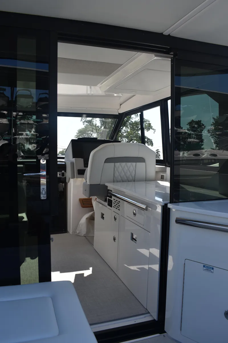 Slide: The Image of 2023 Regal 36 XO yacht interior with modern helm and sleek design. - 23