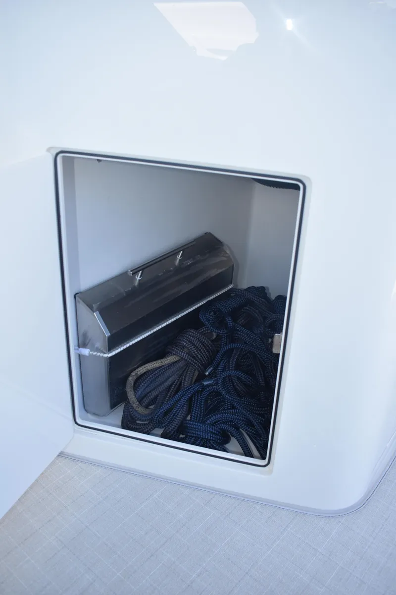 Slide: The Image of Storage compartment on 2023 Regal 36 XO boat with ropes and equipment. - 29