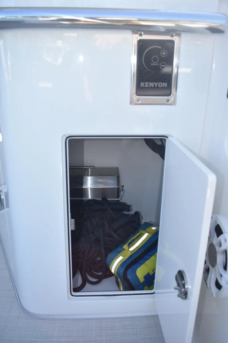 Slide: The Image of 2023 Regal 36 XO boat storage compartment with Kenyon control panel. - 30