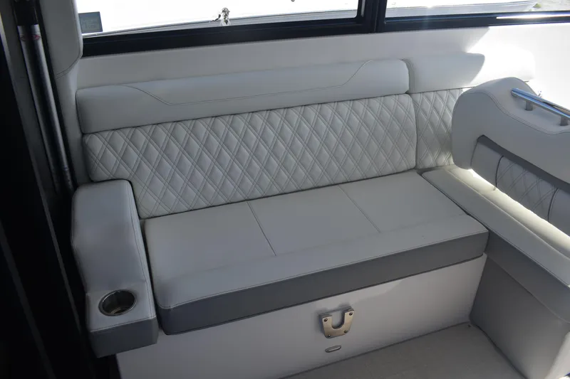 Slide: The Image of Luxurious seating on 2023 Regal 36 XO boat with quilted upholstery and cup holder. - 35