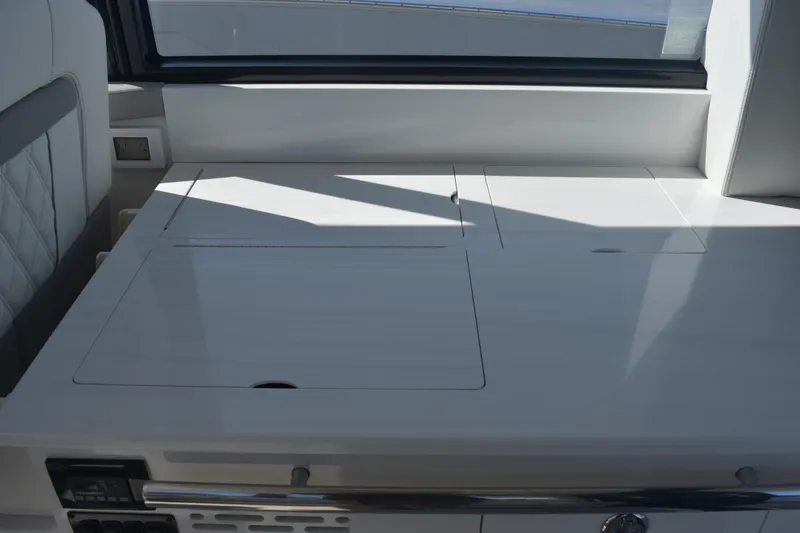 Slide: The Image of 2023 Regal 36 XO yacht interior with sleek, modern design and built-in storage compartments. - 40
