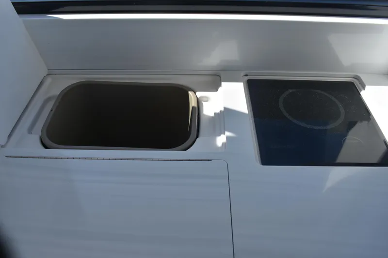 Slide: The Image of 2023 Regal 36 XO boat interior with sink and stove. - 42