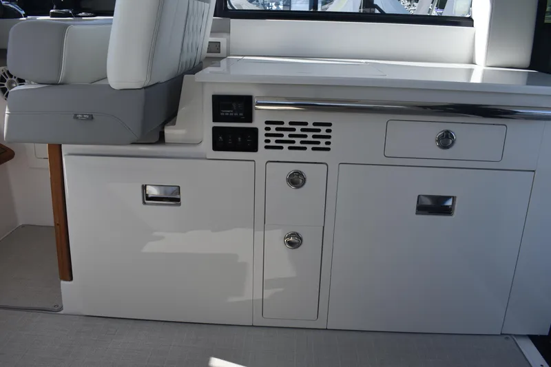 Slide: The Image of 2023 Regal 36 XO yacht interior with sleek white cabinetry and seating. - 47