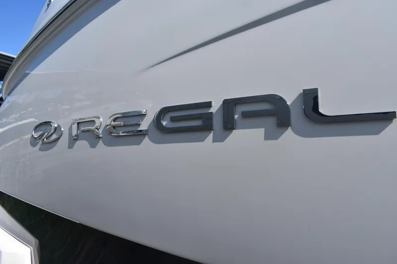 Slide: The Image of 2023 Regal 36 XO boat logo on sleek white hull. - 9