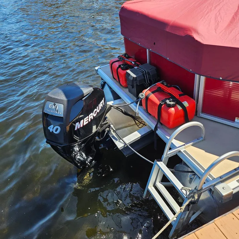 Slide: The Image of 2018 Starcraft EX 18 C pontoon boat with Mercury 40 outboard motor and fuel tanks. - 2